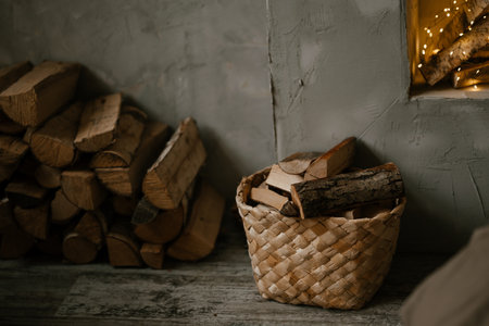 Cozy Firewood Basket and Stack in Rustic Interiorの写真素材