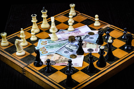 Chess and money on a dark backgroundの写真素材