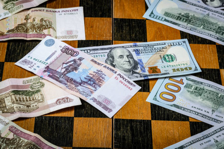 Chess board with cash and chess on a dark backgroundの写真素材