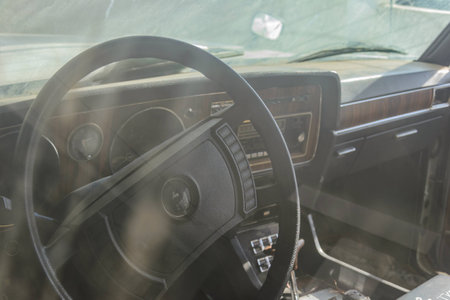 Old abandoned cars covered in dust and rust in the parking lotの写真素材