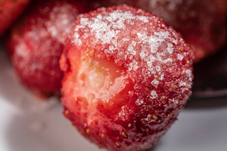 Strawberry berries sprinkled with sugar closeupの写真素材