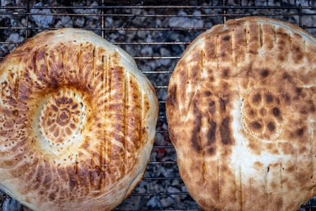 Bread on the grill with open fire and coals