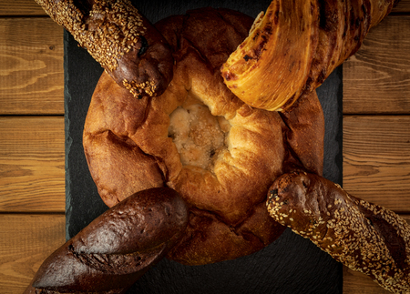 Different types of bread on a wooden backgroundの写真素材