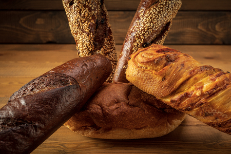 Different types of bread on a wooden backgroundの写真素材