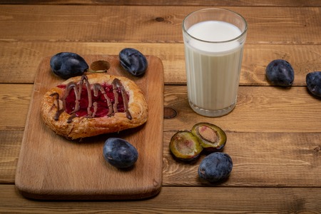 Breakfast.Cheesecake with jam and a glass of milk and a few sipsの写真素材