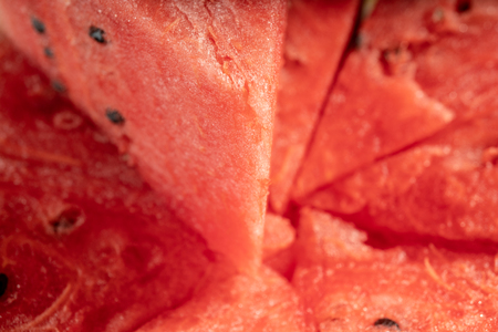 Sliced watermelon on a wooden background close-upの写真素材