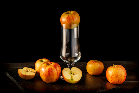 Apple juice in a glass on a black backgroundの写真素材