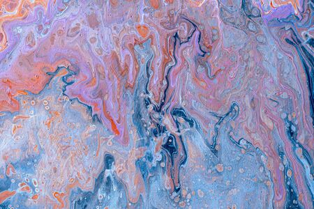 Abstract colored background from spilled paints closeup.