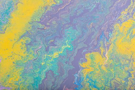 Abstract color background from liquid paints close-up.
