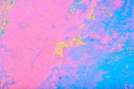 Abstract color background from liquid paints close-up.