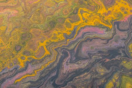 Abstract color background from liquid paints close-up.