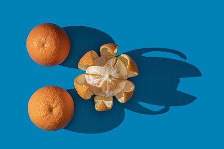 Oranges on a blue background. View from above.の写真素材