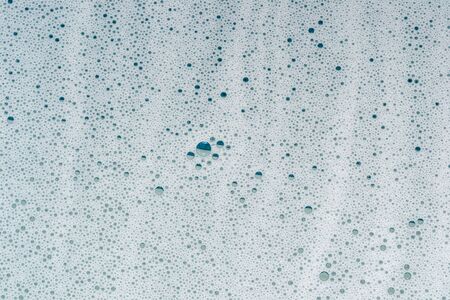 Soapy white foam, shiny water bubbles.