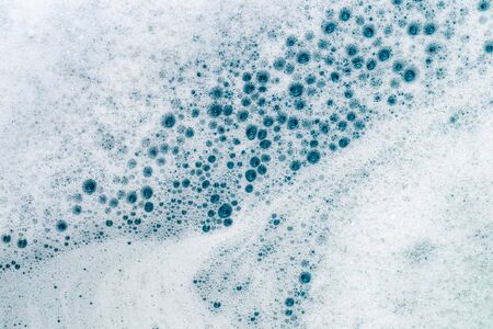 Soapy white foam, shiny water bubbles.