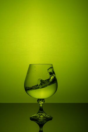 Water splash in a glass on a colored background.の写真素材