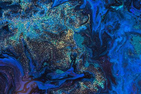 Liquid colored acrylic paints. Abstract colorful background.