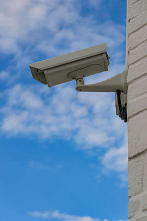 Surveillance camera on a brick wall