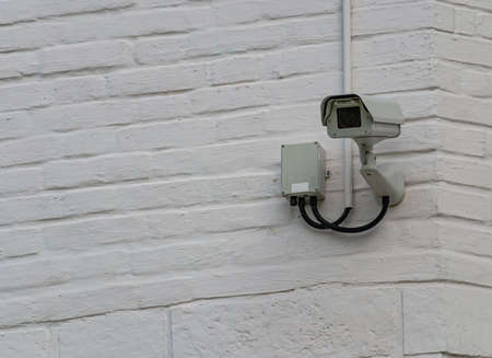 Surveillance camera on a brick wall