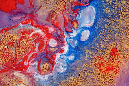Abstract colored background of liquid mixed paints.