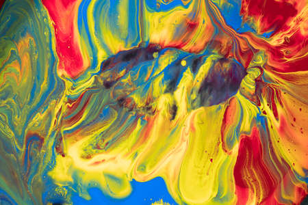 Multicolored paints create a beautiful abstract background.