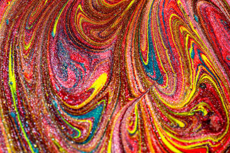 Abstract colorful background of mixed multicolored acrylic paints with sparkles