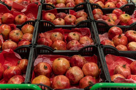 fresh pomegranates on the counter in the supermarketの写真素材