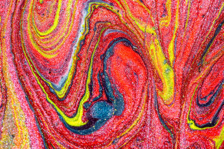Abstract colorful background of mixed multicolored acrylic paints with sparkles