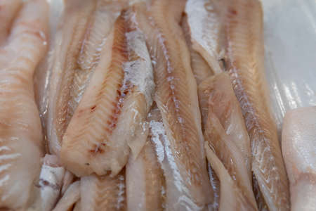 fresh cod fillet lying on ice in a supermarketの写真素材