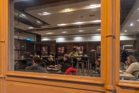 Moscow, Russia - November 5, 2022 : people have a rest in the evening in a cafe