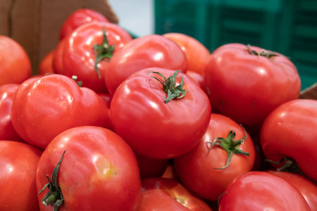 A lot of red tomatoes are sold in a supermarket.の写真素材