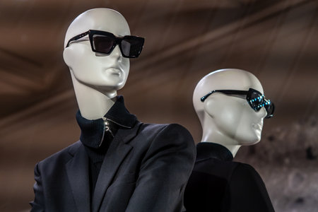 Stylish Mannequins in Black Suits With Sunglasses For Modern Fashion Display.