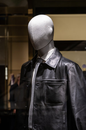 Mannequin Display Featuring Leather Jacket and Tie in Modern Storefront Fashion Scene.の写真素材