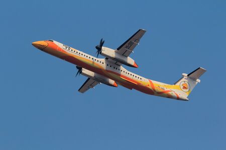 Chiang Mai, Thailand. April 14, 2018. Nok Air De Havilland Canada DHC-8-400 Reg. HS-DQG Taking Off from Chiang Mai International Airport with Blue Sky.のeditorial素材
