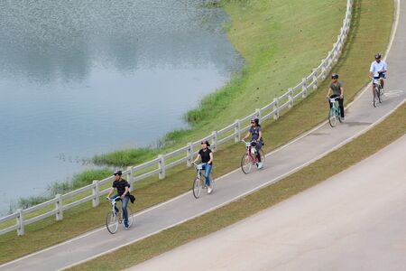 Chiang Rai, Thailand. November 24, 2017.  Group of Tourists are Enjoying Cycling on the Bike Lane Riverside at Singha Park Chiang Rai, Thailand.のeditorial素材