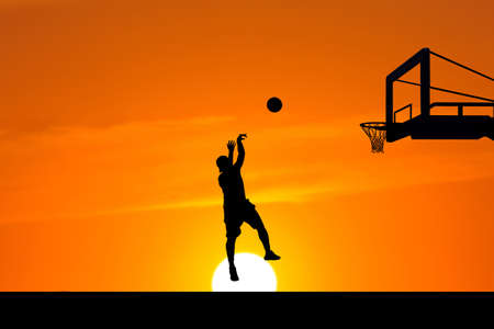 Silhouette image of a professional basketball player.の写真素材