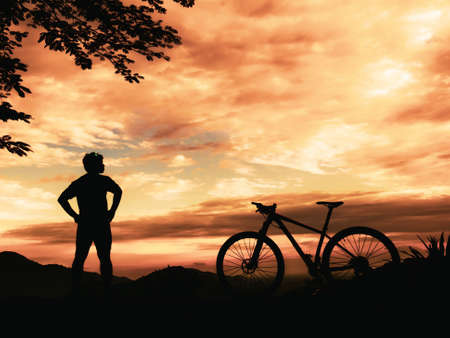 Silhouette of a mountain bike mechanic. Relaxing on a beautiful viewの写真素材