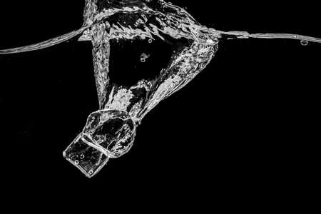 Water splash abstract shape with ice cubes isolated on black background.の写真素材