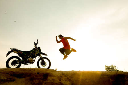 man with motorcycle in the eveningの写真素材