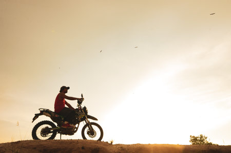 man with motorcycle in the eveningの写真素材