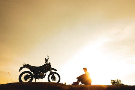 man with motorcycle in the eveningの写真素材