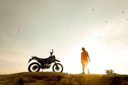 man with motorcycle in the eveningの写真素材