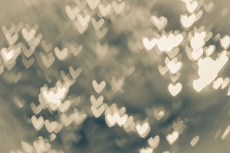 Abstract background of heart-shaped bokeh created by blurred lens. Use it as a background in any...