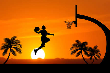 Basketball players jumping dunk silhouettes on a beautiful outdoor basketball court in the evening.の写真素材
