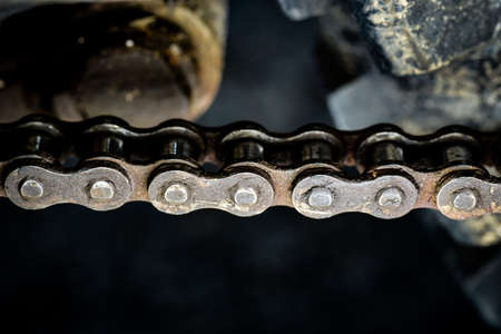 Dirty sprockets and chains show signs of wear and tear.の写真素材