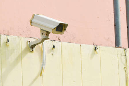 CCTV is installed on the wall of the building for safety.
