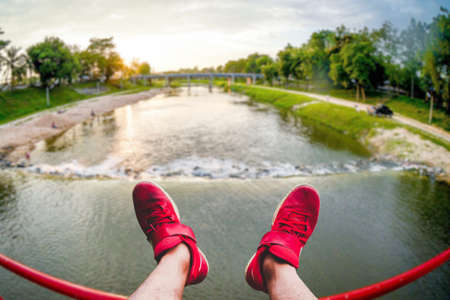 The red tourist shoes happily extended into the beautiful scenery. Travel ideas after the Covid-19 crisisの写真素材