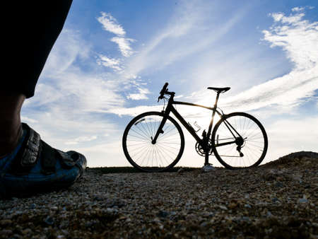 Silhouette of a bicycle parked on the beach in the evening. Silhouette of with bicycles at sunset. beautiful landscape image with Bicycle at sunsetの写真素材