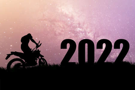 Concept Happy new year 2022 Silhouette image of happy man from 2021 up to 2022 on beautiful skyの写真素材