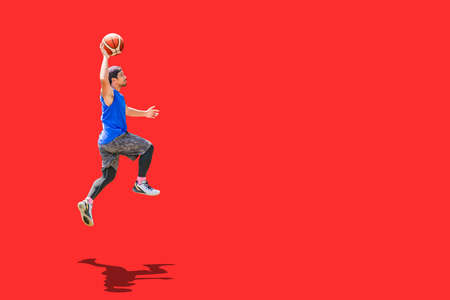 Asian basketball player jumping dunk to score on colored backgroundの写真素材