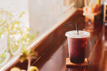 A plastic coffee mug placed at the counter gives a warm glow in the morning.